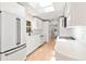 Modern kitchen featuring white cabinets, skylight, and stainless steel appliances at 2410 Floyd St, Sarasota, FL 34239