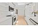 Modern kitchen with sleek white cabinets and stainless steel appliances at 2410 Floyd St, Sarasota, FL 34239