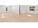 Bright living room with wood flooring, white walls, and natural light from a window and door at 2410 Floyd St, Sarasota, FL 34239