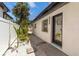 Pathway alongside home exterior with gravel and access door at 2410 Floyd St, Sarasota, FL 34239