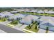 Stunning aerial view of homes with lush landscaping and a serene pond at 2631 Sapphire Blue Ln, Bradenton, FL 34211