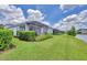 Manicured backyard landscaping with a screened patio overlooking the pond at 2631 Sapphire Blue Ln, Bradenton, FL 34211