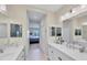 Well-lit bathroom features dual sinks, large mirrors, and tile flooring, providing a clean and functional space at 2631 Sapphire Blue Ln, Bradenton, FL 34211