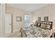 Bedroom featuring natural light from a window, a bed with patterned linens, and neutral colors at 2631 Sapphire Blue Ln, Bradenton, FL 34211