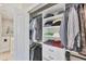 Organized walk-in closet with shelving, hanging racks, and easy access to the bathroom at 2631 Sapphire Blue Ln, Bradenton, FL 34211