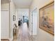 Bright hallway with hardwood floors leading to dining and living areas with backyard views at 2631 Sapphire Blue Ln, Bradenton, FL 34211