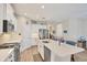 Bright kitchen showcasing white cabinets, an island with seating, and stainless steel appliances at 2631 Sapphire Blue Ln, Bradenton, FL 34211