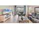 Cozy living room with modern decor, wood floors, and a view of the serene backyard at 2631 Sapphire Blue Ln, Bradenton, FL 34211