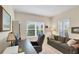 Comfortable home office featuring a desk, sofa, and natural light from two windows, perfect for productivity at 2631 Sapphire Blue Ln, Bradenton, FL 34211