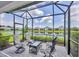 Enjoy serene lake views from this screened-in patio with seating at 2631 Sapphire Blue Ln, Bradenton, FL 34211