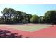 Outdoor tennis courts surrounded by lush greenery on a clear sunny day at 2650 Coconut Bay Ln # 521, Sarasota, FL 34237