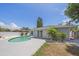 Backyard features a pool, white privacy fence, patio, and lovely landscaping at 2953 Oak St, Sarasota, FL 34237