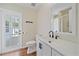 Stylish bathroom featuring a modern vanity, toilet, and a glass door leading to the outdoor patio at 2953 Oak St, Sarasota, FL 34237
