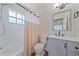 Updated bathroom featuring a shower/tub combo, new vanity with modern fixtures, and a framed mirror at 2953 Oak St, Sarasota, FL 34237