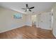 Spacious bedroom featuring wood-look flooring, ceiling fan, and natural light from the window at 2953 Oak St, Sarasota, FL 34237