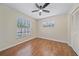 This bedroom has wood-look flooring, a ceiling fan, a closet, and a window overlooking the pool at 2953 Oak St, Sarasota, FL 34237
