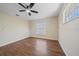 Bright bedroom featuring wood-look flooring, ceiling fan, and a large window for ample natural light at 2953 Oak St, Sarasota, FL 34237
