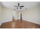 This primary bedroom offers wood floors, ceiling fan, and an ensuite bath at 2953 Oak St, Sarasota, FL 34237