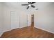 Neutral bedroom featuring wood floors, ceiling fan, closet, and open doorway at 2953 Oak St, Sarasota, FL 34237