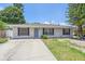 Well-maintained home with a manicured lawn, shutters and a concrete driveway at 2953 Oak St, Sarasota, FL 34237