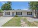 Charming single-story home features a gray exterior, dark shutters, and manicured lawn at 2953 Oak St, Sarasota, FL 34237