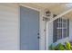 Front door of the home with stylish light fixture and visible address number at 2953 Oak St, Sarasota, FL 34237