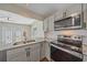 Modern kitchen boasts granite countertops, stainless steel appliances, and backyard views at 2953 Oak St, Sarasota, FL 34237