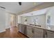Open kitchen features granite countertops, stainless steel appliances, and wood flooring at 2953 Oak St, Sarasota, FL 34237