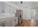 Bright kitchen boasts stainless steel refrigerator and modern grey cabinetry at 2953 Oak St, Sarasota, FL 34237