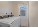 Functional laundry room with washer, dryer, and utility door at 2953 Oak St, Sarasota, FL 34237