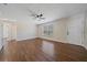 Living room showcasing new wood-look floors, ceiling fan and a front-facing window at 2953 Oak St, Sarasota, FL 34237