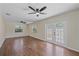 Bright living room boasts wood floors, ceiling fan, and French doors at 2953 Oak St, Sarasota, FL 34237