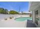 Backyard showcases a kidney-shaped pool with white fence, concrete deck, and landscaping at 2953 Oak St, Sarasota, FL 34237
