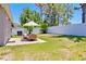 The home has a nice backyard, patio area, furniture, landscaping, and a privacy fence at 3429 97Th E Ln, Palmetto, FL 34221