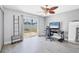 Bright bedroom featuring sliding glass doors, neutral walls, ceiling fan, and modern decor at 3429 97Th E Ln, Palmetto, FL 34221