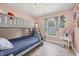 Light bedroom with bunk beds, wood-look floors, window, and cute decor at 3429 97Th E Ln, Palmetto, FL 34221
