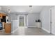 Bright dining area with sliding glass doors, modern lighting, and an open layout to kitchen at 3429 97Th E Ln, Palmetto, FL 34221