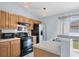 Updated kitchen with stainless steel appliances, wood cabinetry, and breakfast bar area at 3429 97Th E Ln, Palmetto, FL 34221