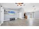 Open living space with wood-look floors, high ceilings, and a view of the kitchen area at 3429 97Th E Ln, Palmetto, FL 34221