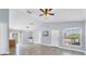 Open-concept living area featuring wood-look floors, large windows, and a seamless flow to kitchen at 3429 97Th E Ln, Palmetto, FL 34221