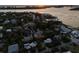 Serene aerial view of a waterfront neighborhood at sunset, showcasing lush landscaping and water access at 3446 Anglin Dr, Sarasota, FL 34242