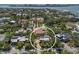 Aerial view of the property showing mature landscaping, tennis courts, and nearby waters at 3446 Anglin Dr, Sarasota, FL 34242
