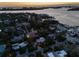Stunning aerial view of luxury homes nestled among lush greenery at dusk, near the water at 3446 Anglin Dr, Sarasota, FL 34242