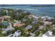 Aerial view of the homes in the community showing mature landscaping, tennis courts, and nearby waters at 3446 Anglin Dr, Sarasota, FL 34242