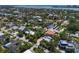 Aerial showing neighborhood homes with mature landscaping, tennis courts, and access to bay waters at 3446 Anglin Dr, Sarasota, FL 34242