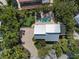 Aerial view of a luxury home showcasing a private pool, lush landscaping, and spacious outdoor living areas at 3446 Anglin Dr, Sarasota, FL 34242