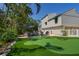 Landscaped backyard with putting green, pool, spa and patio at 3446 Anglin Dr, Sarasota, FL 34242