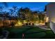 Beautiful backyard featuring a putting green, outdoor seating, pool, and lush tropical landscaping at 3446 Anglin Dr, Sarasota, FL 34242