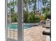 Lush backyard with a pool, jacuzzi, and patio area, perfect for outdoor relaxation and entertaining at 3446 Anglin Dr, Sarasota, FL 34242