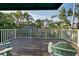 Private balcony with a relaxing green chair overlooking beautiful tropical foliage and landscaping at 3446 Anglin Dr, Sarasota, FL 34242